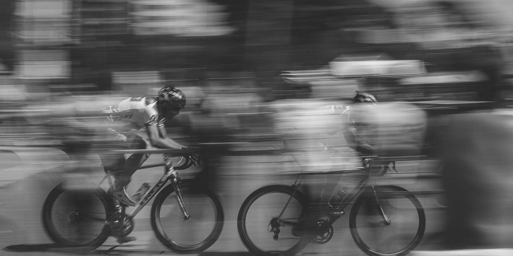 Cyclists racing past in a motion blur